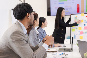 Group of business people working together with dashboard analysis and data management a meeting table in an office.