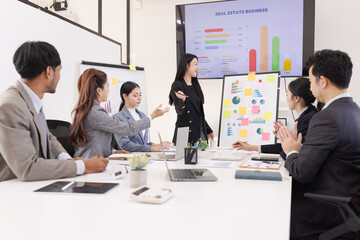Group of business people working together with dashboard analysis and data management a meeting table in an office.