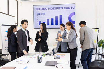 Group of business people working together with dashboard analysis and data management a meeting table in an office.