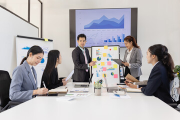 Group of business people working together with dashboard analysis and data management a meeting table in an office.
