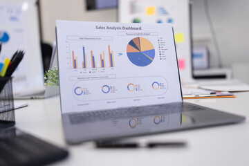 Computer laptop with plan analysis at desk in modern office, Documents discussion analysis data.