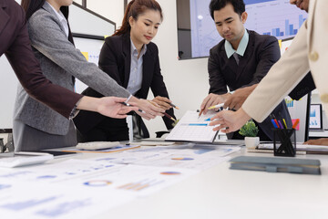 Group of business people working together with dashboard analysis and data management a meeting table in an office.