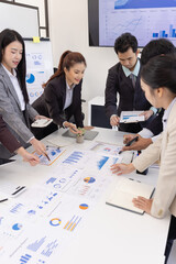 Fototapeta premium Group of business people working together with dashboard analysis and data management a meeting table in an office.