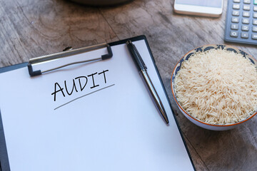 The word 'AUDIT' is prominently displayed, a bowl of rice, signifying sustenance and generosity,...