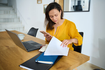 Freelance Professional Working from Cozy Home Office with Laptop and Documents