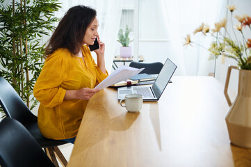 Businesswoman Working Remotely in a Bright and Stylish Home Office Setting