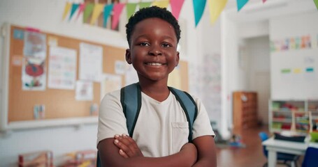 Happy, face and black child with crossed arms in classroom for learning, education or development. Bag, portrait and African boy student with confidence for back to school at elementary academy.