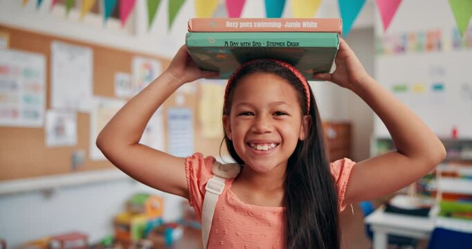 Balance, books and face of girl child in school classroom for development, growth or learning. Future, knowledge and smile with happy student in academy for elementary study or youth scholarship