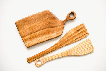 Kitchen board made of wood on a white background. Kitchen board made of walnut wood.