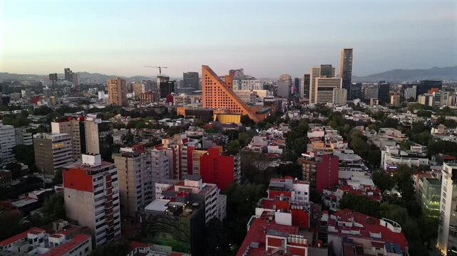  Flying over upscale Polanco district at dusk with towers and modern architecture. Mexico City, Mexico.