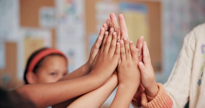 Teacher, students and high five in classroom, hands and support with mind development at academy. Education, motivation huddle and gesture for learning success, school celebration and woman with kids