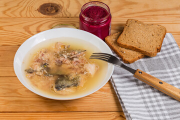 Serving of jellied fish with horseradish sauce on rustic table