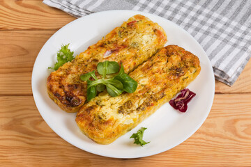 Rectangular vegetable casseroles with beaten eggs and cheese on dish