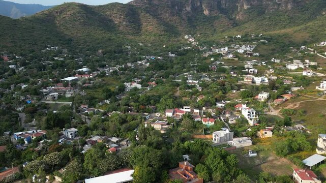 Flying over homes in green mountain village of Malinalco, Mexico.