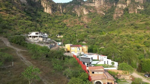 Flying towards new houses under construction in mountain village called Malinalco. Mexico.