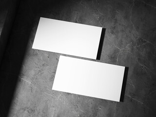 A clean business card placed on a textured stone surface, featuring sharp, well-defined shadows,...