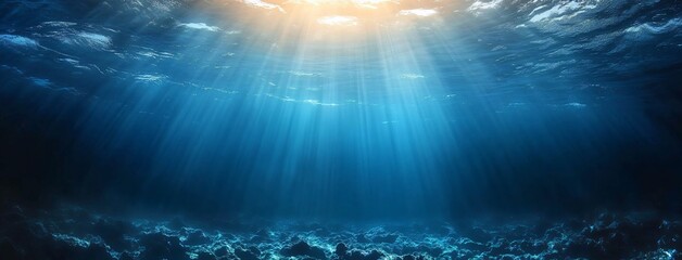 A serene underwater scene captures sunlight filtering through deep blue waters, ideal for ocean-related themes, relaxation, travel, and marine awareness events.