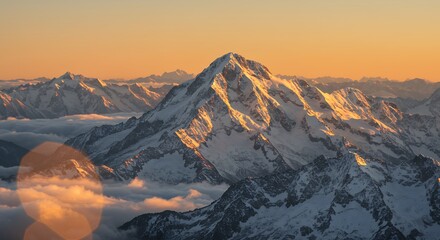 Snowy Mountain Peak at Sunset with Warm Light and Clouds