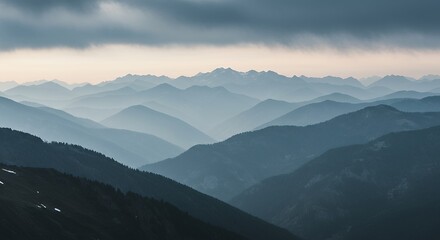 Layered Mountain Landscape with Atmospheric Haze Under Cloudy Sky