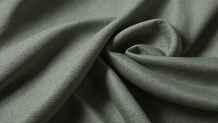 A sage green linen fabric background. Soft muted green linen fabric with elegant folds. Seamless sage green textile texture.