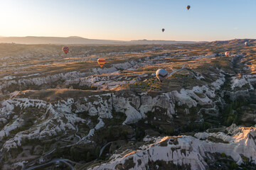 Colorful hot air balloon flying over Cappadocia, Turkey. Hot air balloons flying in sunrise sky.