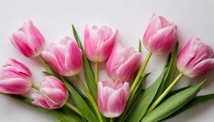 Obraz premium Pink tulips forming a beautiful bouquet on white wooden background