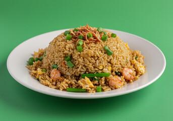 Shrimp Fried Rice on White Plate Against Green Background