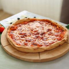 Top view of pizza with cured ham, cheese, tomatoes, copy space, moc up