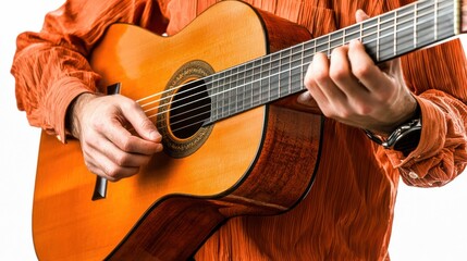 Obraz premium Acoustic Guitarist Holding Instrument in Isolated Studio Setting with Orange Shirt and Textured Finish