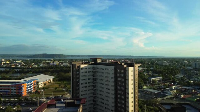 High rise apartment building above streets in Iloilo at sunset