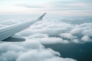 Obraz premium Airplane Wing Over Soft Clouds and Blue Sky During Daytime Flight