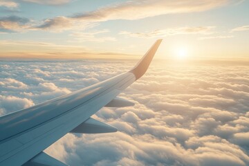 Obraz premium Serene View of Airplane Wing Above Fluffy Clouds During Sunset