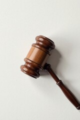 A Polished Wooden Gavel on a Plain Surface, Symbolizing Justice and Legal Decisions