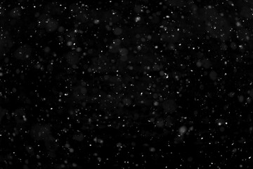 Texture of natural falling snow on black background.