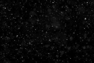 Texture of natural falling snow on black background.