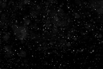 Texture of natural falling snow on black background.