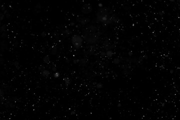Texture of natural falling snow on black background.