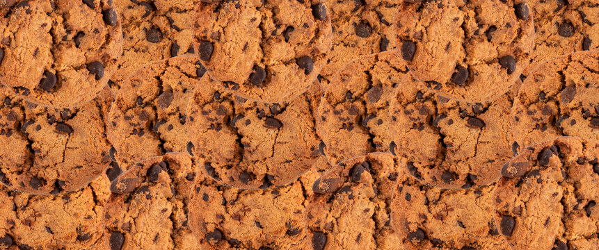 Chocolate chips cookies textured background, American biscuits pattern, cocoa confectionery