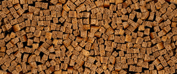 Homemade rye bread croutons texture background top view. Crispy bread cubes pattern
