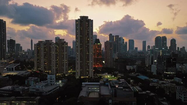 Golden Horizons: Captivating Evening Aerial of Mumbai's Skyline at Sunset, Over Lower Parel, Mahalaxmi, and Currey Road. Silhouette shot of Mumbai's skyline in the evening.
