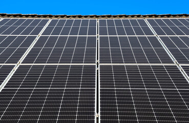 Solar panels converting sunlight into renewable energy on rooftop