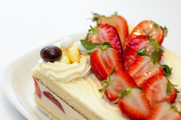 A white plate with a strawberry cake on it