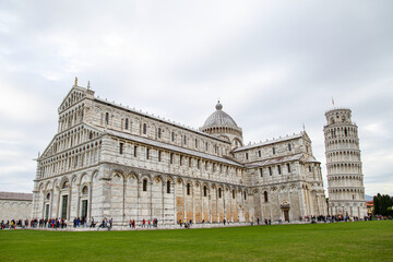 A large white building with a dome on top and a tower in Pisa Italy Toscana