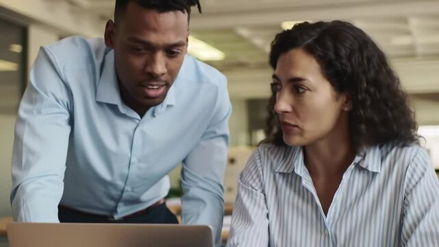 Business team, two professional executives working together on computer at work. Manager consulting employee using laptop talking on financial project management in office.