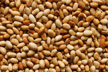 Roasted pine nuts, close-up, macro. Pine nuts background