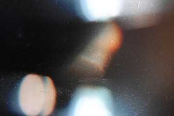 Designed film texture background with heavy grain, dust and a light leak Real Lens Flare Shot in...
