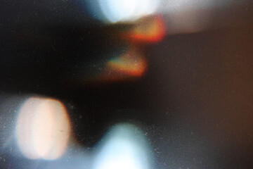 Designed film texture background with heavy grain, dust and a light leak Real Lens Flare Shot in...