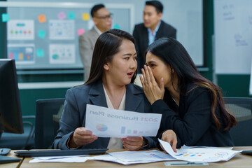 group of asian office worker woman talking or whispering gossip with colleague rumors to coworker...