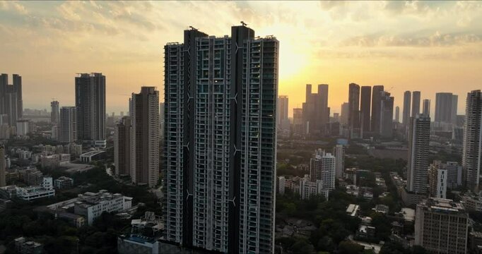 Golden Horizons: Captivating Evening Aerial of Mumbai's Skyline at Sunset, Over Lower Parel, Mahalaxmi, and Currey Road. Silhouette shot of Mumbai's skyline in the evening.
