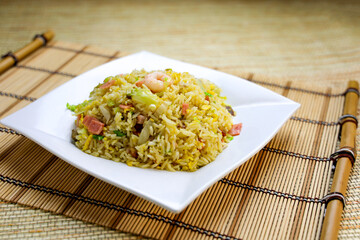 Yang Chow Fried Rice with Shrimp, ham, vegetables, and egg served in plate isolated on table side view of Hong Kong food